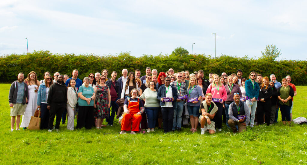 Group photo of the Solutions for Accounting team stood in a field