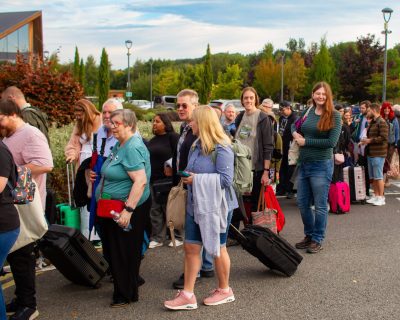 Solutions for Accounting employees and their partners lining up to get on the bus at the start of the Mystery Tour Weekend 2025